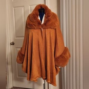 Cognac sweater cape with faux fur collar and cuffs.  One size fits most.